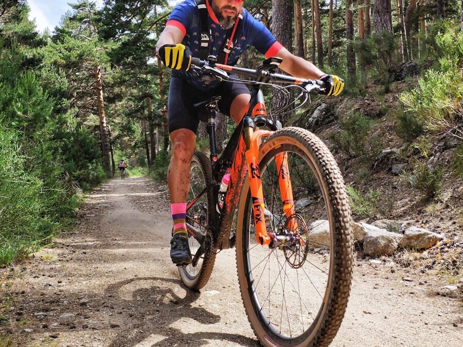 man in black and yellow bicycle suit riding on red and black mountain bike